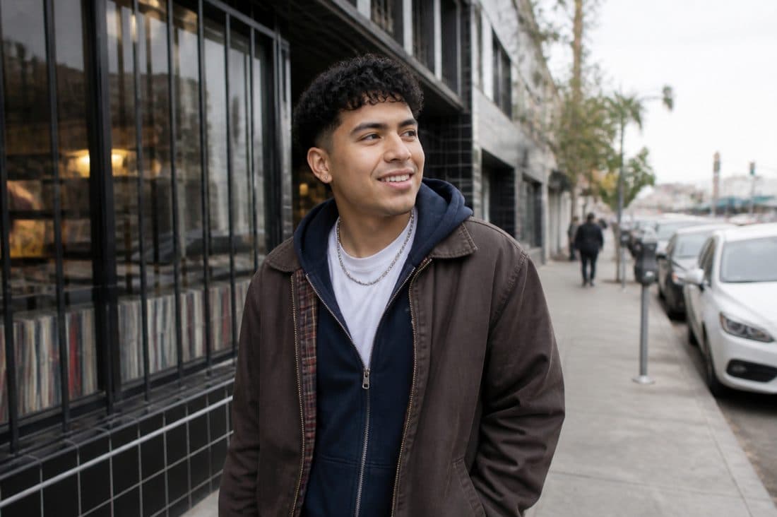 Illustrative adult wearing relaxed layers outdoors